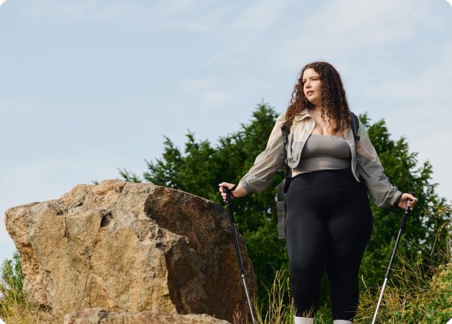 Woman out walking in the countryside with hiking poles